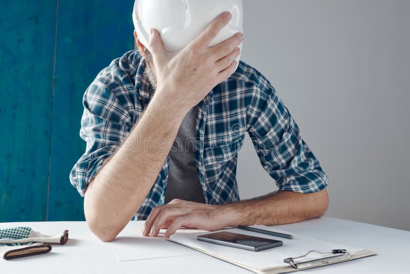 Worried construction engineer project manager after reviewing notes royalty free stock images