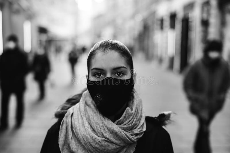 Worried depressed woman walking to work in the public during the pandemic.Effect of the COVID-19.Protective measure,mask wearing.