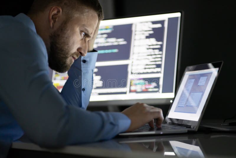 Worried Programmer Working Late At Night stock photo