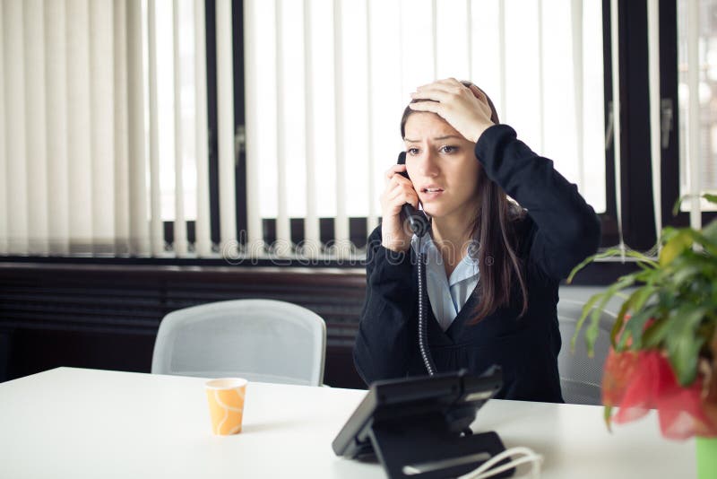 Worried stressed depressed office worker business woman receiving bad news emergency phone call at work.Looking confused. Communication, corporate.