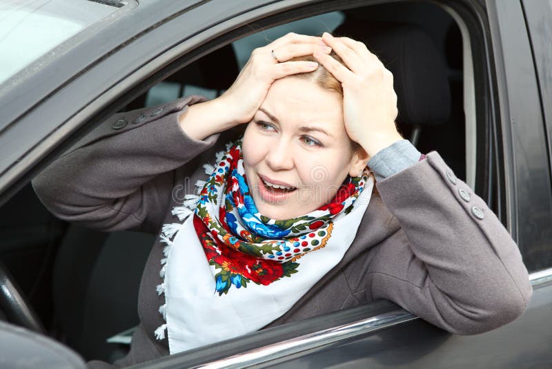 Worried woman in car stock photo