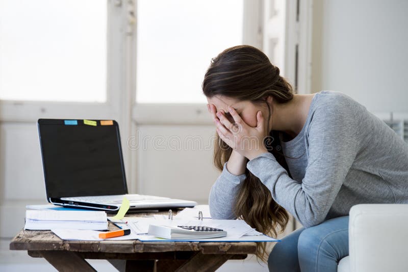 Worried woman suffering stress doing domestic accounting paperwork bills and invoices