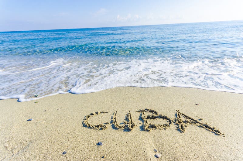 CUBA, creative abstract graphic message for your summer design. Inscription on wet sand word CUBA drawn on the sand of a beach at ocean horizon. Concept photo of summer vacation. CUBA, creative abstract graphic message for your summer design. Inscription on wet sand word CUBA drawn on the sand of a beach at ocean horizon. Concept photo of summer vacation.