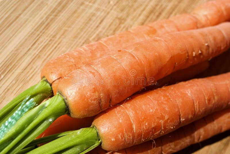 Carrots on wooden cutting board. Carrots on wooden cutting board