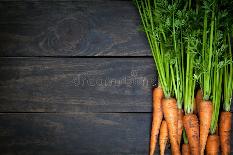 Carrots on wooden table background. Copy space. Top view. Carrots on wooden table background. Copy space. Top view