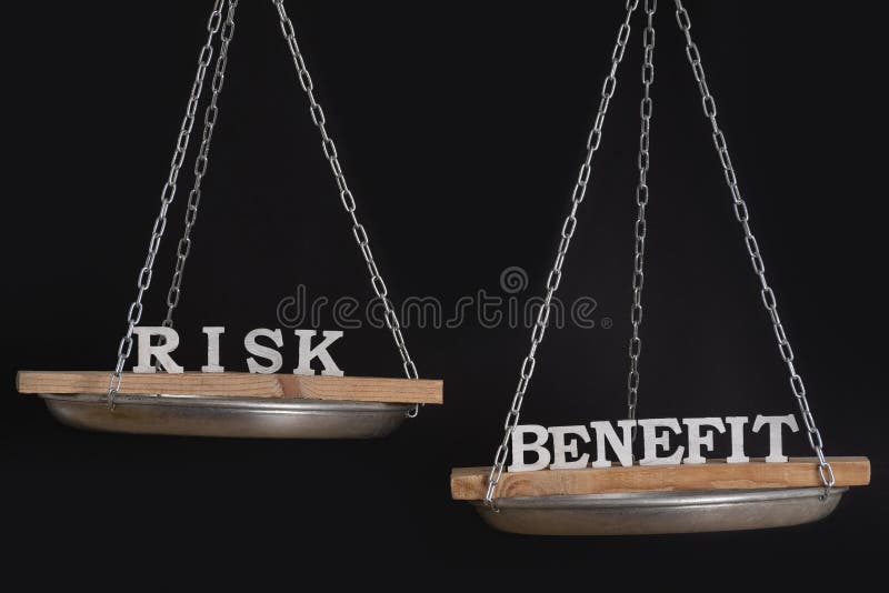 Words Risk and benefit in balance. Concept of equilibrium. Scales on black background. Words Risk and benefit in balance. Concept of equilibrium. Scales on black background.