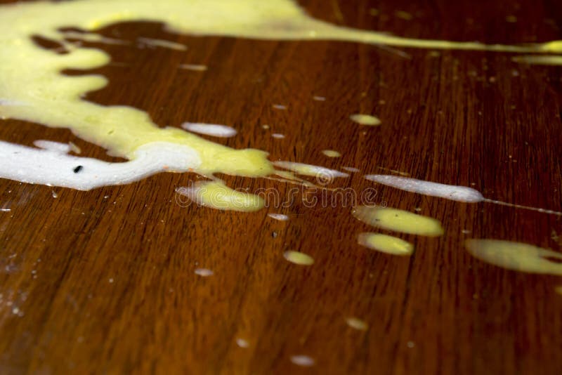 Spilled candle wax mess on wood table. Spilled candle wax mess on wood table.