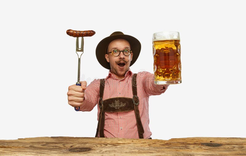 Wow. Young expressive man in hat, wearing fest traditional German costume with huge glass of beer isolated on white background. Concept of alcohol, traditions, holidays, Oktoberfest. Copy space for ad. Wow. Young expressive man in hat, wearing fest traditional German costume with huge glass of beer isolated on white background. Concept of alcohol, traditions, holidays, Oktoberfest. Copy space for ad