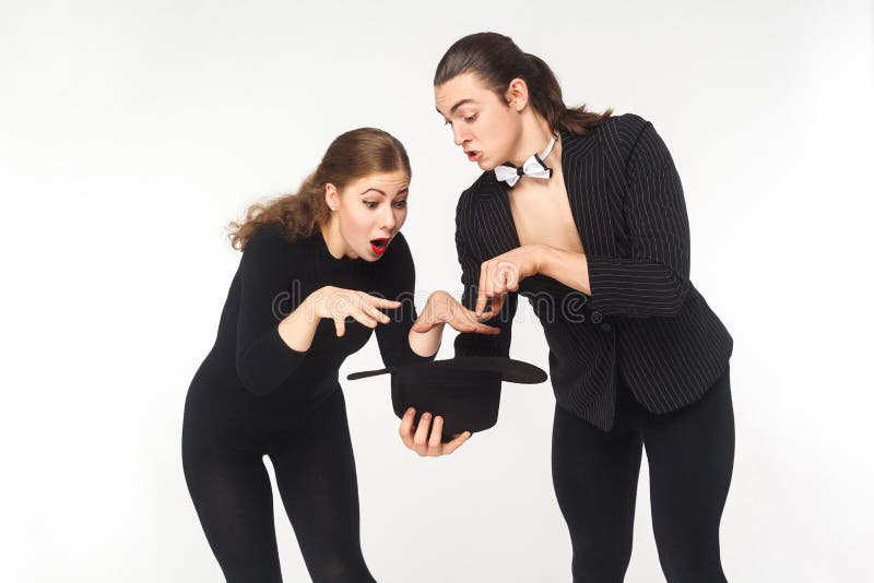 Wow! Magic inside hat. Man showing Imagination trick young woman royalty free stock photo Wow! Magic inside hat. Man showing Imagination trick young woman royalty free stock photo
