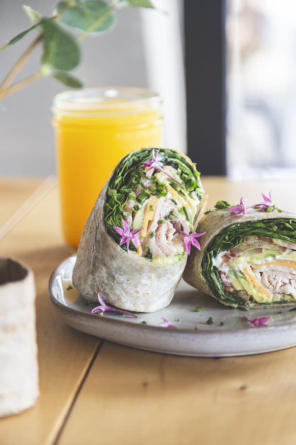 Wrap with Lettuce, Tomato, Ham and Cheese on the Table of a Fancy