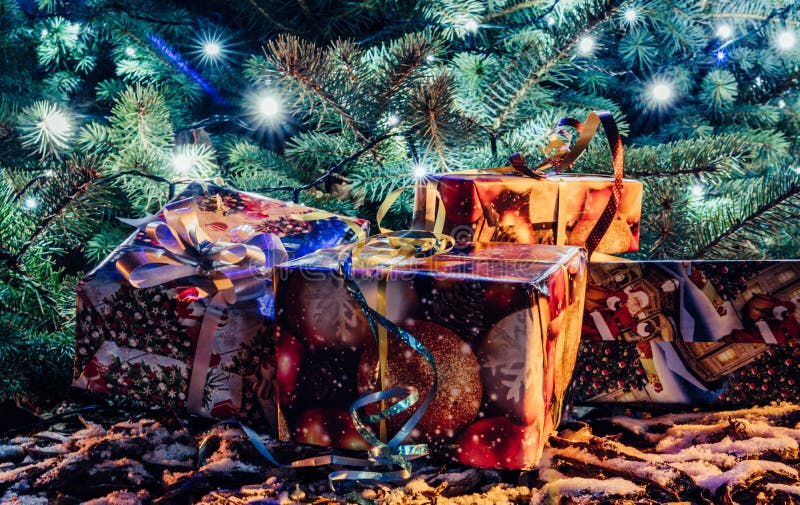 Wrapped Christmas Presents Under the Christmas Tree with Lights Stock