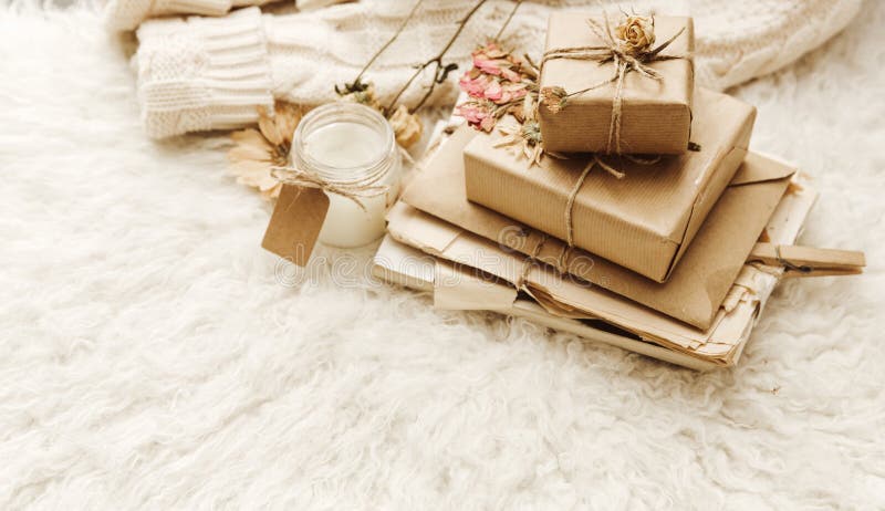 Wrapped craft gift boxes with dry flowers over fur background. royalty free stock photography Wrapped craft gift boxes with dry flowers over fur background. royalty free stock photography