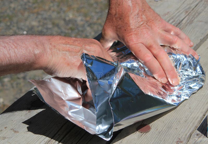 Wrapping with tin foil stock photo. Image of barbeque 56887246