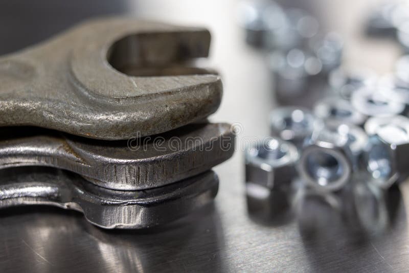 Wrench and Nuts on a Metal Table in a Accessories for