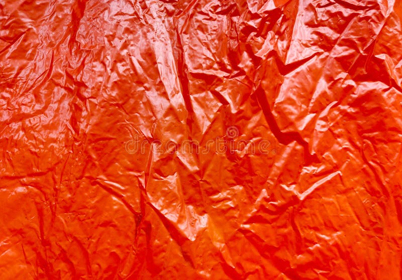 Wrinkled Orange Glossy Paper As a Background Texture Stock Image