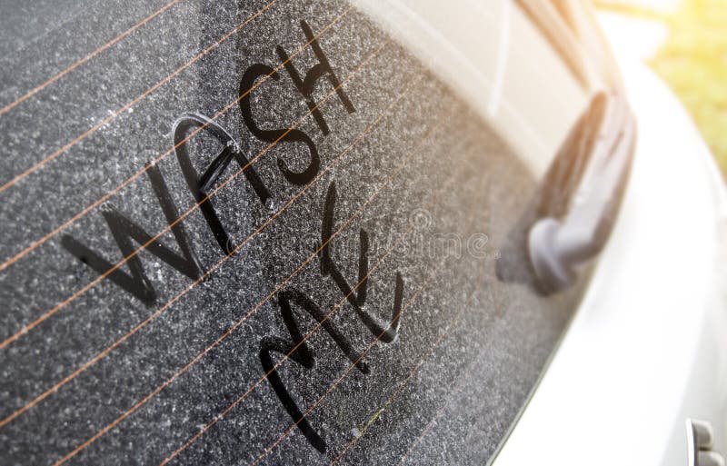 Write the words `wash me` on the very dirty surface of the car.