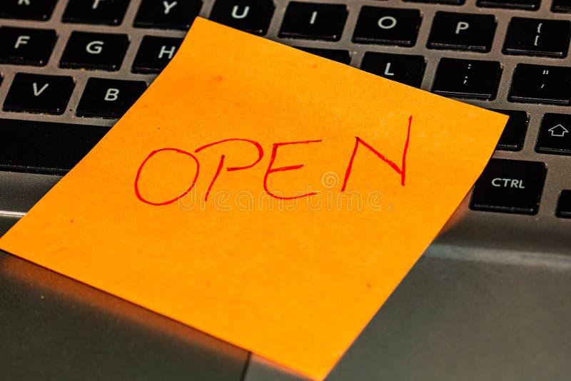 Writing on colorful sticky note Open. Text with Open on paper. Sticky note, post it on keyboard stock photo