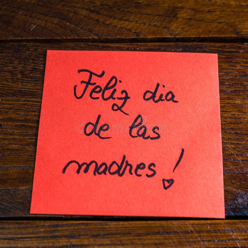 Writing happy mother`s day in Spanish feliz dia de las madres on memo post reminder. Text on sticky paper. Mother`s day concept.  royalty free stock photo