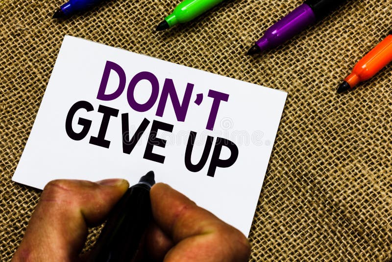 Writing note showing Don t not Give Up. Business photo showcasing Determined Persevering Continue to Believe in Yourself Man hand