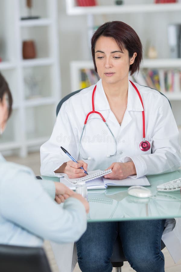 Writing prescription after diagnosing sick patient stock images Writing prescription after diagnosing sick patient stock images