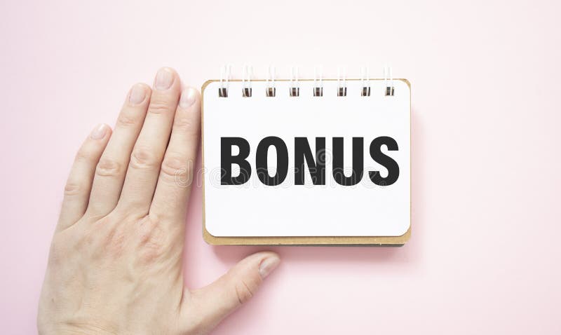 Writing text showing Bonus. Writing text Bonus on white paper card, black letters, white background. royalty free stock photos