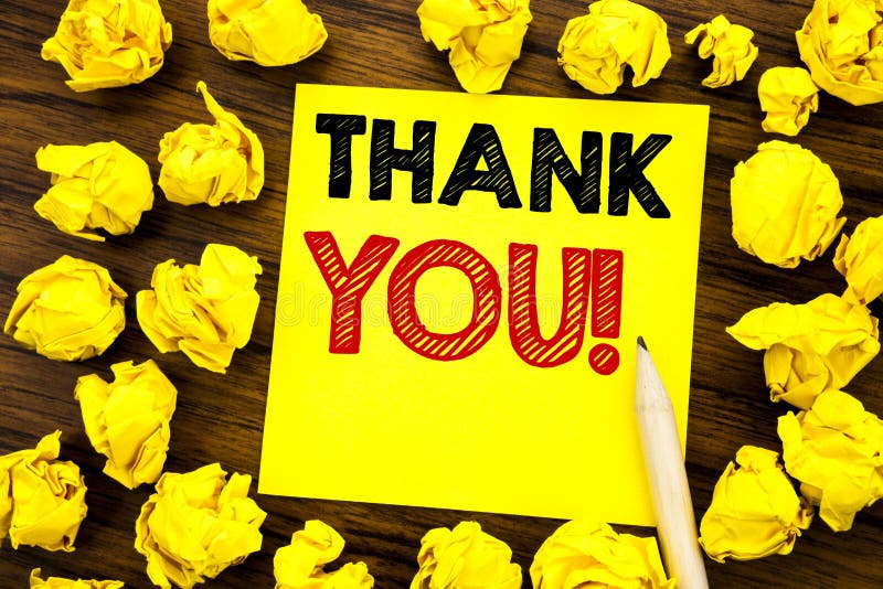 Writing text showing Thank You. Business concept for Thanks Message Written on sticky note paper, wooden background with folded ye royalty free stock photography