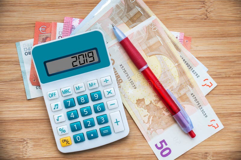 2019 written on a calculator and euros banknotes on wood background royalty free stock photography 2019 written on a calculator and euros banknotes on wood background royalty free stock photography
