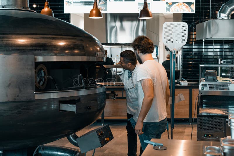 The kitchen chef turns on Marana Forni Gea pizza oven.