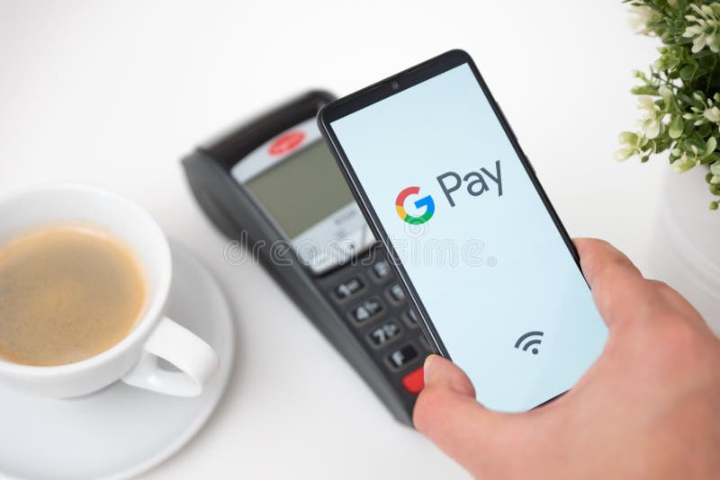 Man holding smartphone with Google Pay logo. Wroclaw, Poland - NOV 06, 2019: Man holding smartphone with Google Pay logo. Google Pay is electronic wallet stock photography