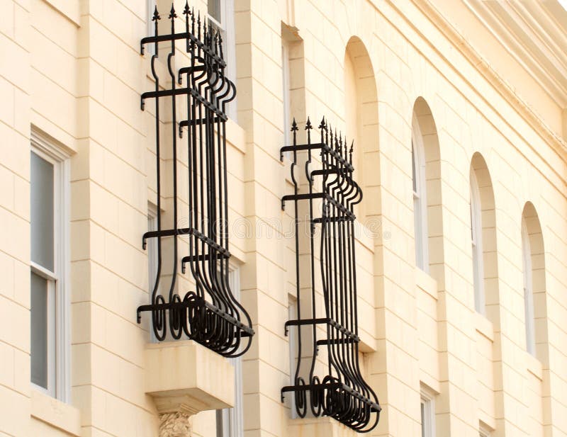 Wrought iron bars around windows stock image
