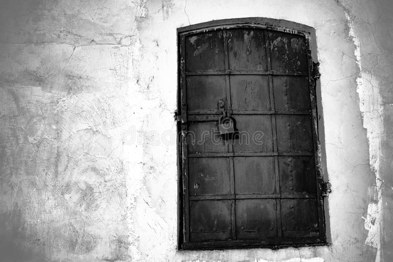 Wrought iron metal door and white wall of an old historic building. Black and white background, retro, vintage stock photos Wrought iron metal door and white wall of an old historic building. Black and white background, retro, vintage stock photos