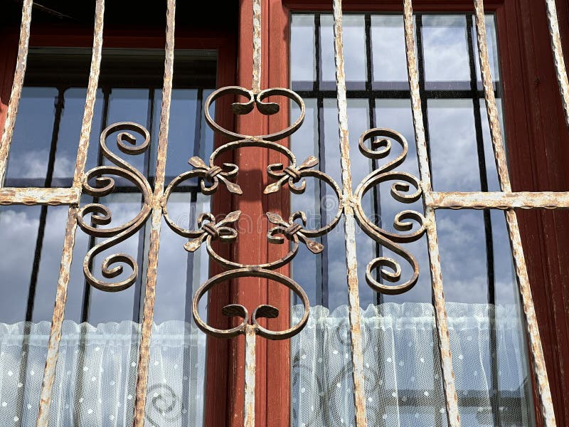 Wrought iron ornaments on the window of a house stock photography