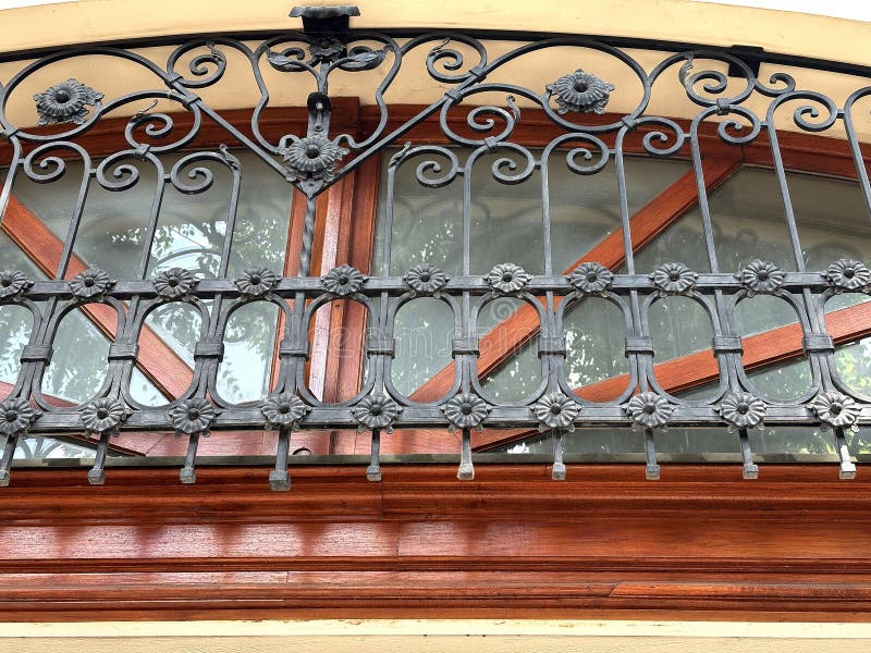 Wrought iron ornaments on the window of a house stock images
