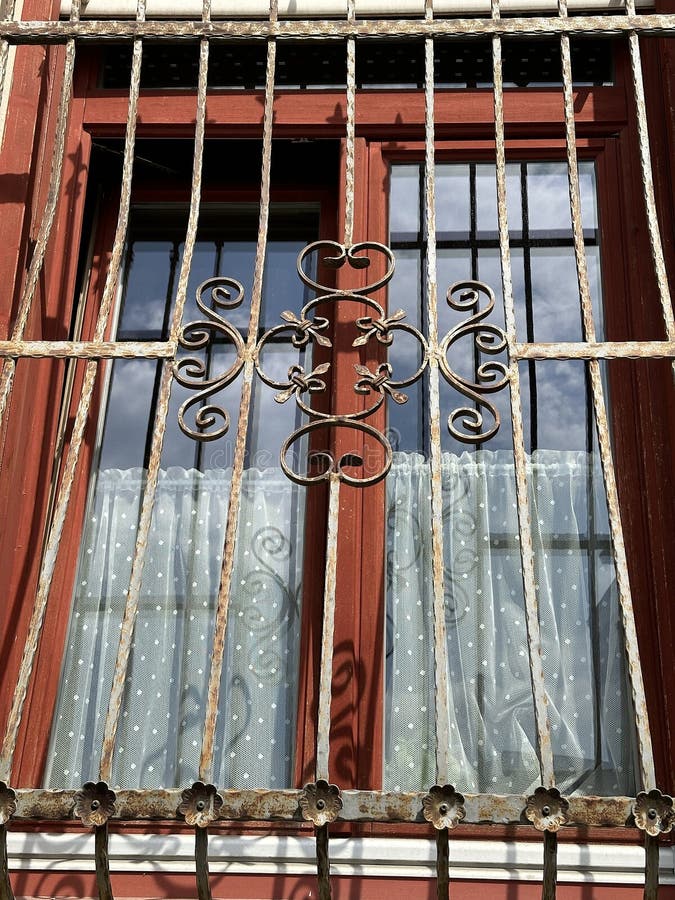 Wrought iron ornaments on the window of a house royalty free stock photography