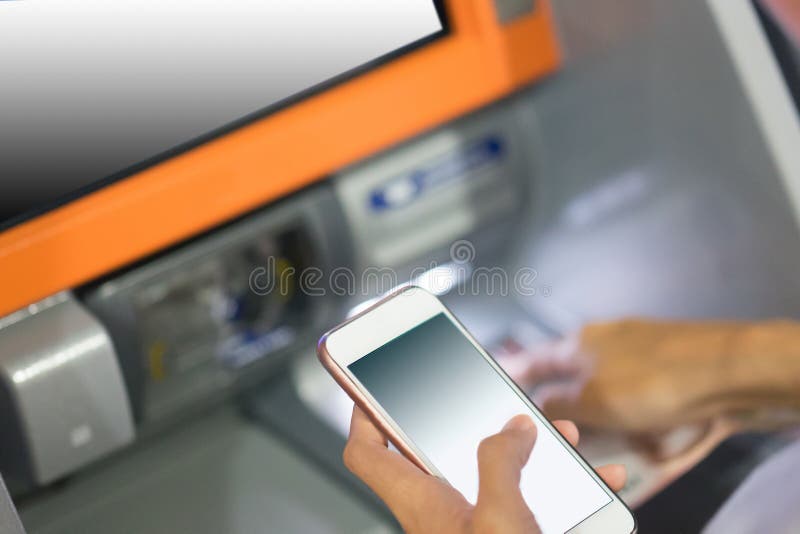 Wręcza wkładać kredytową kartę w atm trzyma mądrze telefon zdjęcia royalty free Wręcza wkładać kredytową kartę w atm trzyma mądrze telefon zdjęcia royalty free