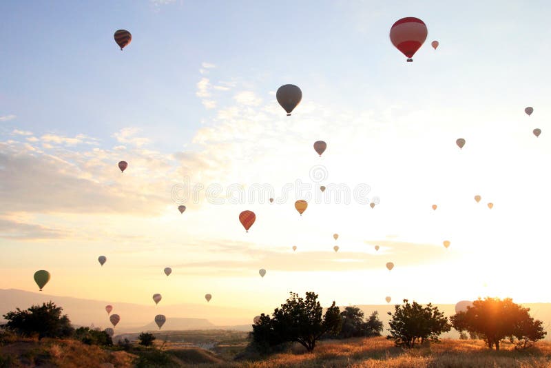 Travel to Goreme, Cappadocia, Turkey. The sunrise in the mountains with a lot of air hot balloons in the sky. Travel to Goreme, Cappadocia, Turkey. The sunrise in the mountains with a lot of air hot balloons in the sky.