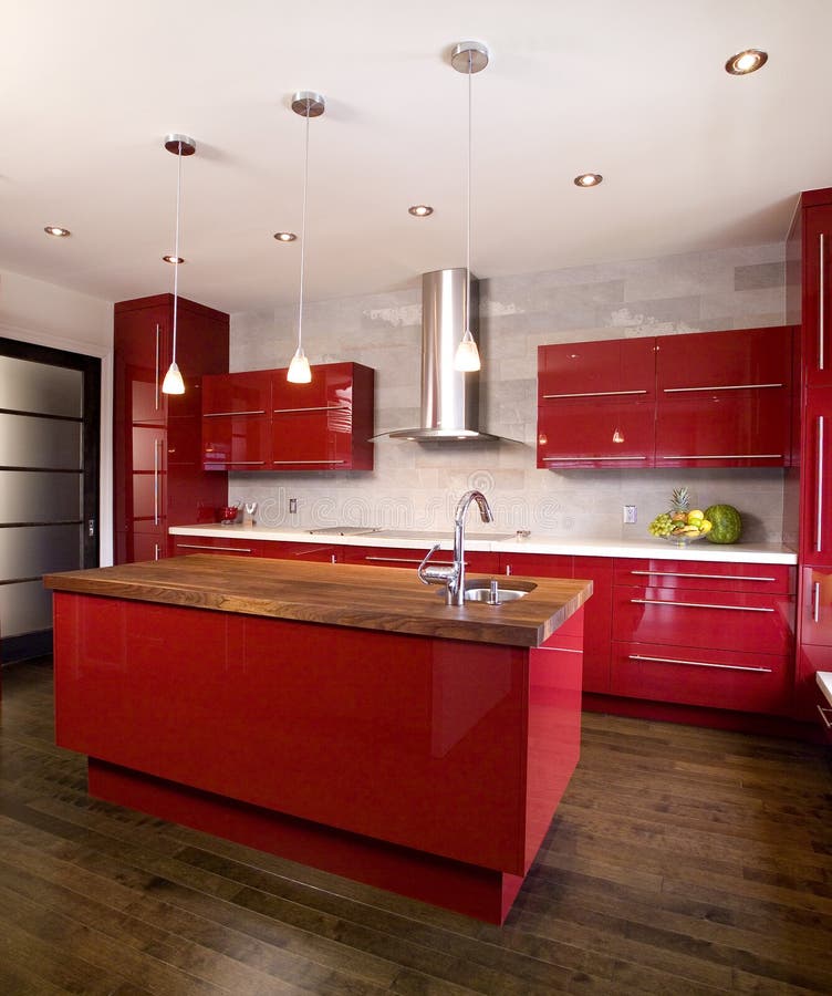 Contemporary red modern kitchen with island and wooden counter top and stainless steel range hood. Contemporary red modern kitchen with island and wooden counter top and stainless steel range hood