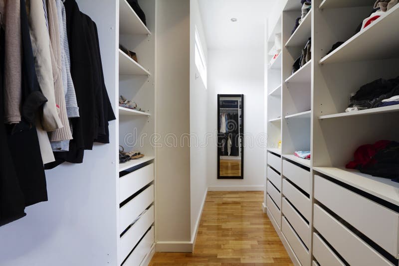 Contemporary spacious walk in wardrobe in a modern home. Contemporary spacious walk in wardrobe in a modern home