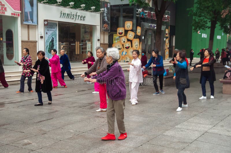 WUHAN,CHINA - April 22, 2019 - People performing exercise in the morning at the city. Qigong class stock images, royalty-free photos and pictures