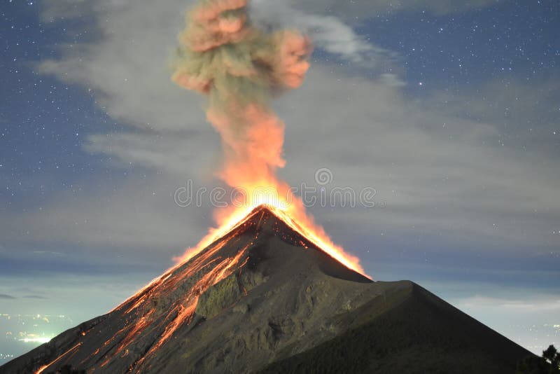 Picture shot on the Acatenango Volcano, near Antigua in Guatemala. We can see the lava and lava rocks going down the sides of the volcano, with a bit of the city lights in the distance. Picture shot on the Acatenango Volcano, near Antigua in Guatemala. We can see the lava and lava rocks going down the sides of the volcano, with a bit of the city lights in the distance.