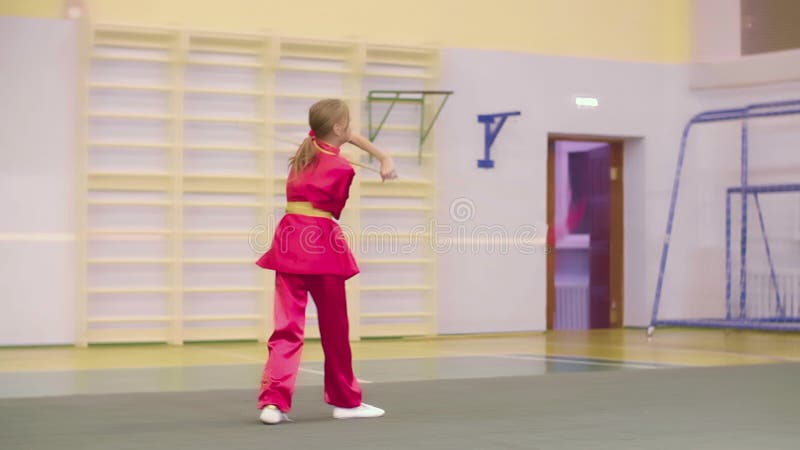 Wushu young girl training with spear, martial arts