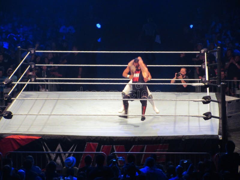 WWE Wrestler Kevin Owens goes for a stunner on Andrade in ring