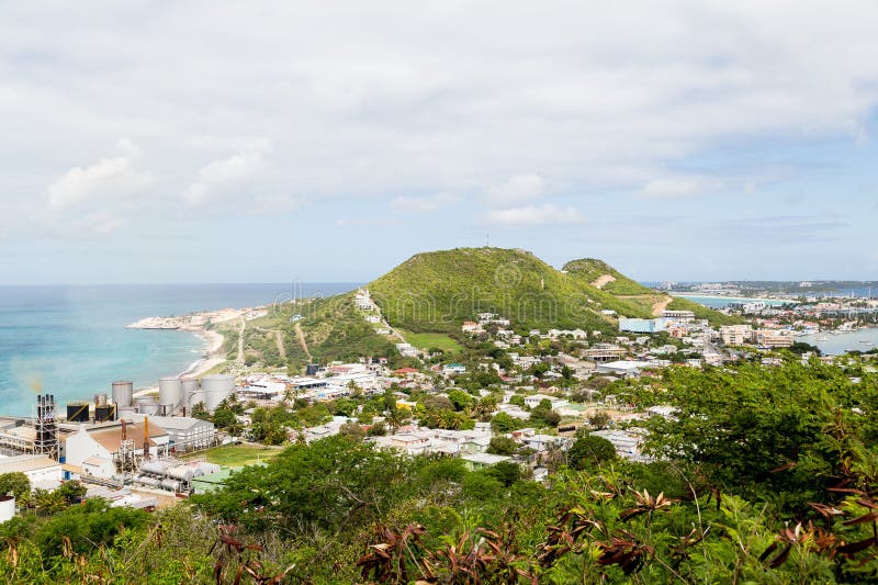 A view of bay on St Martin from hill with sugar factory on coast. A view of bay on St Martin from hill with sugar factory on coast