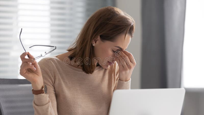 Head shot exhausted female employee took off glasses, massaging nose bridge, suffering from dry eyes syndrome. Tired executive manager feeling pain in eyes, overloaded with computer work at office. Head shot exhausted female employee took off glasses, massaging nose bridge, suffering from dry eyes syndrome. Tired executive manager feeling pain in eyes, overloaded with computer work at office.