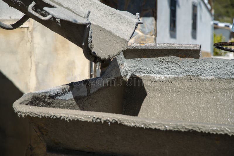 Dumper machine waiting to be loaded with liquid concrete through the truck's outlet. Dumper machine waiting to be loaded with liquid concrete through the truck's outlet