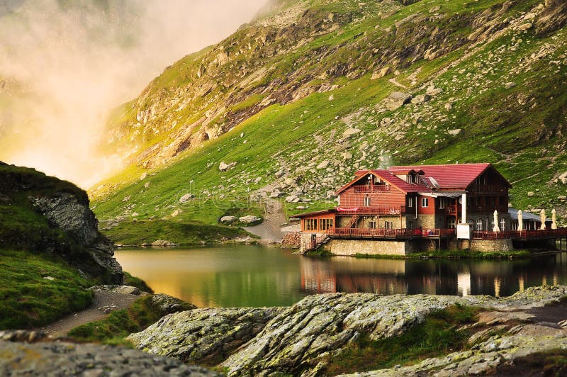 The BÃ¢lea Lake is a glacier lake situated at 2,034 m of altitude in the FÄƒgÄƒraÅŸ Mountains, in central Romania, in Sibiu County. There are two chalets opened all the year round, a meteorological station and a mountain rescue station. It is accessible by car on the TransfÄƒgÄƒrÄƒÅŸan road during the summer, and the rest of the year by a cable car from the BÃ¢lea Waterfall chalet. The resort offers nature trails medium-advanced class, is a real paradise for lovers of extreme sports. Here you can practice ski, snowboard, gave the bag, sleighing, etc.. Partia Balea Lac is one of the most popular ski slopes in Romania by professionals and those who love extreme sports. Snow is present in November / December to July and has a very good quality for carrying skiâ€™s. The photo was taken this summer, on a road trip and it was a very foggy day. This dreamy landscape is spectacular and the traditional cabin on the lake is wonderful. The BÃ¢lea Lake is a glacier lake situated at 2,034 m of altitude in the FÄƒgÄƒraÅŸ Mountains, in central Romania, in Sibiu County. There are two chalets opened all the year round, a meteorological station and a mountain rescue station. It is accessible by car on the TransfÄƒgÄƒrÄƒÅŸan road during the summer, and the rest of the year by a cable car from the BÃ¢lea Waterfall chalet. The resort offers nature trails medium-advanced class, is a real paradise for lovers of extreme sports. Here you can practice ski, snowboard, gave the bag, sleighing, etc.. Partia Balea Lac is one of the most popular ski slopes in Romania by professionals and those who love extreme sports. Snow is present in November / December to July and has a very good quality for carrying skiâ€™s. The photo was taken this summer, on a road trip and it was a very foggy day. This dreamy landscape is spectacular and the traditional cabin on the lake is wonderful