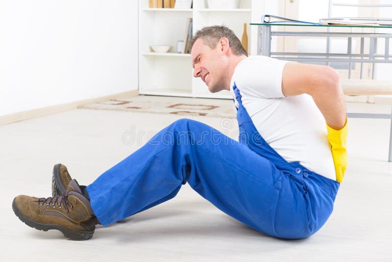 Man worker with back injury, concept of accident at work. Man worker with back injury, concept of accident at work