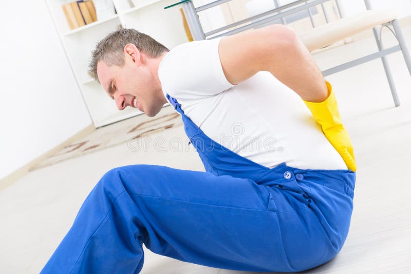 Man worker with back injury, concept of accident at work. Man worker with back injury, concept of accident at work