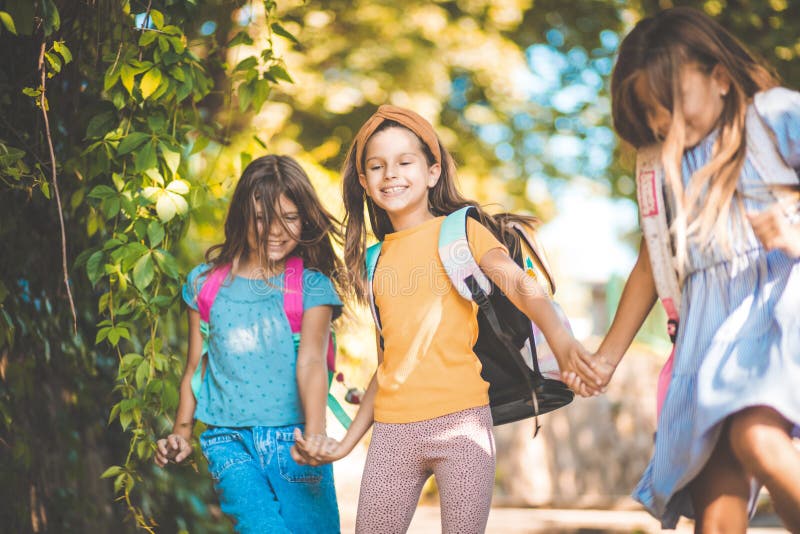 Enough school for today. Three little girls running trough nature with school bag on back. Enough school for today. Three little girls running trough nature with school bag on back
