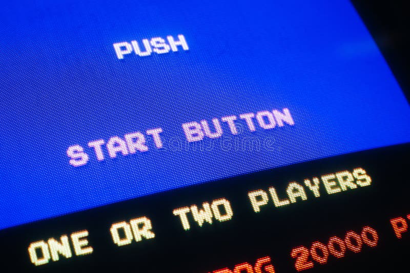 Detail Macro of an old vintage video game with text Push start button, with option to select one or two players. Detail Macro of an old vintage video game with text Push start button, with option to select one or two players